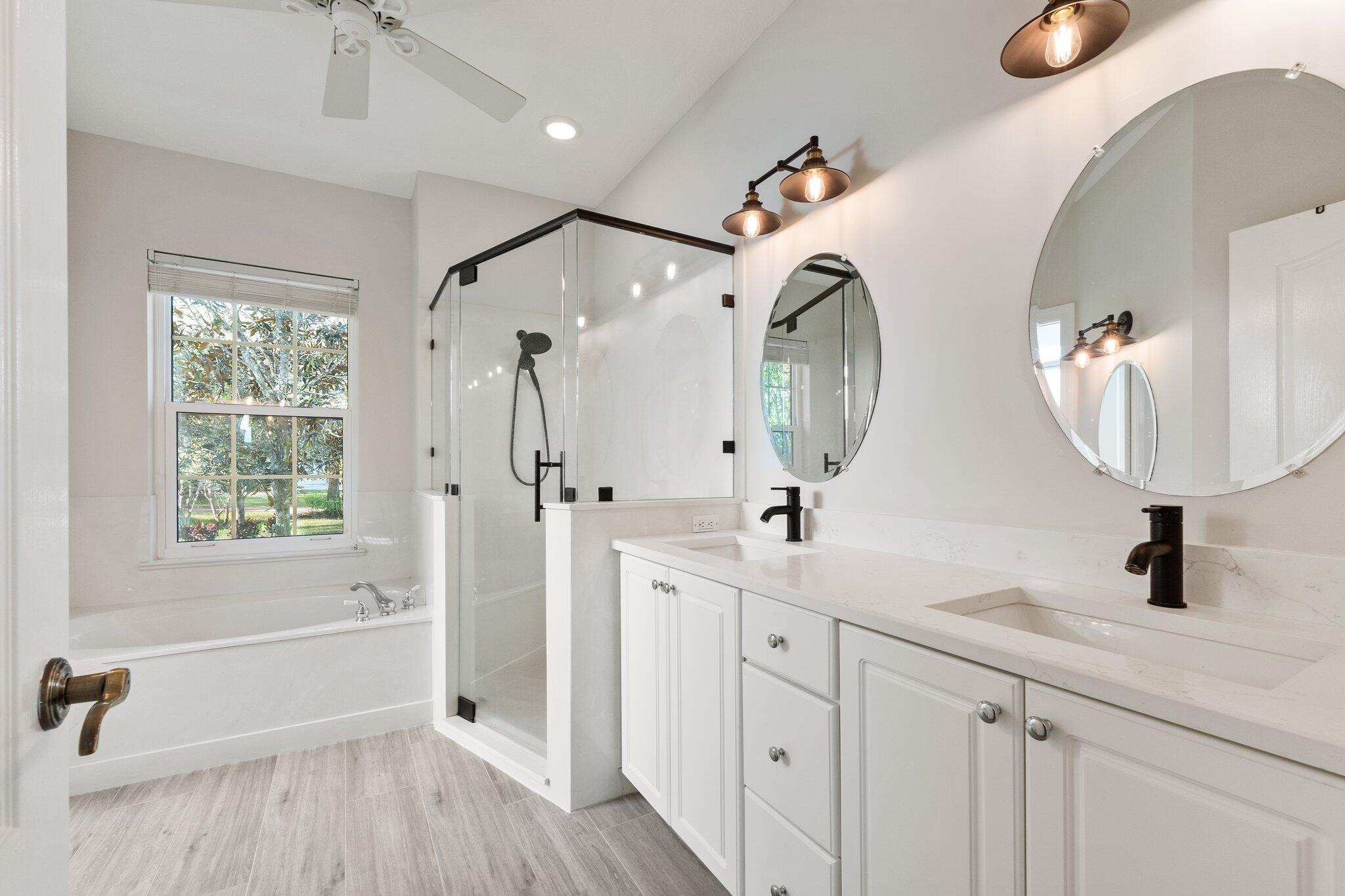 1680 Southeast Cypress Glen Way Stuart, FL 34997 - Photo 44 of 76 a bathroom with a double vanity sink mirror and shower