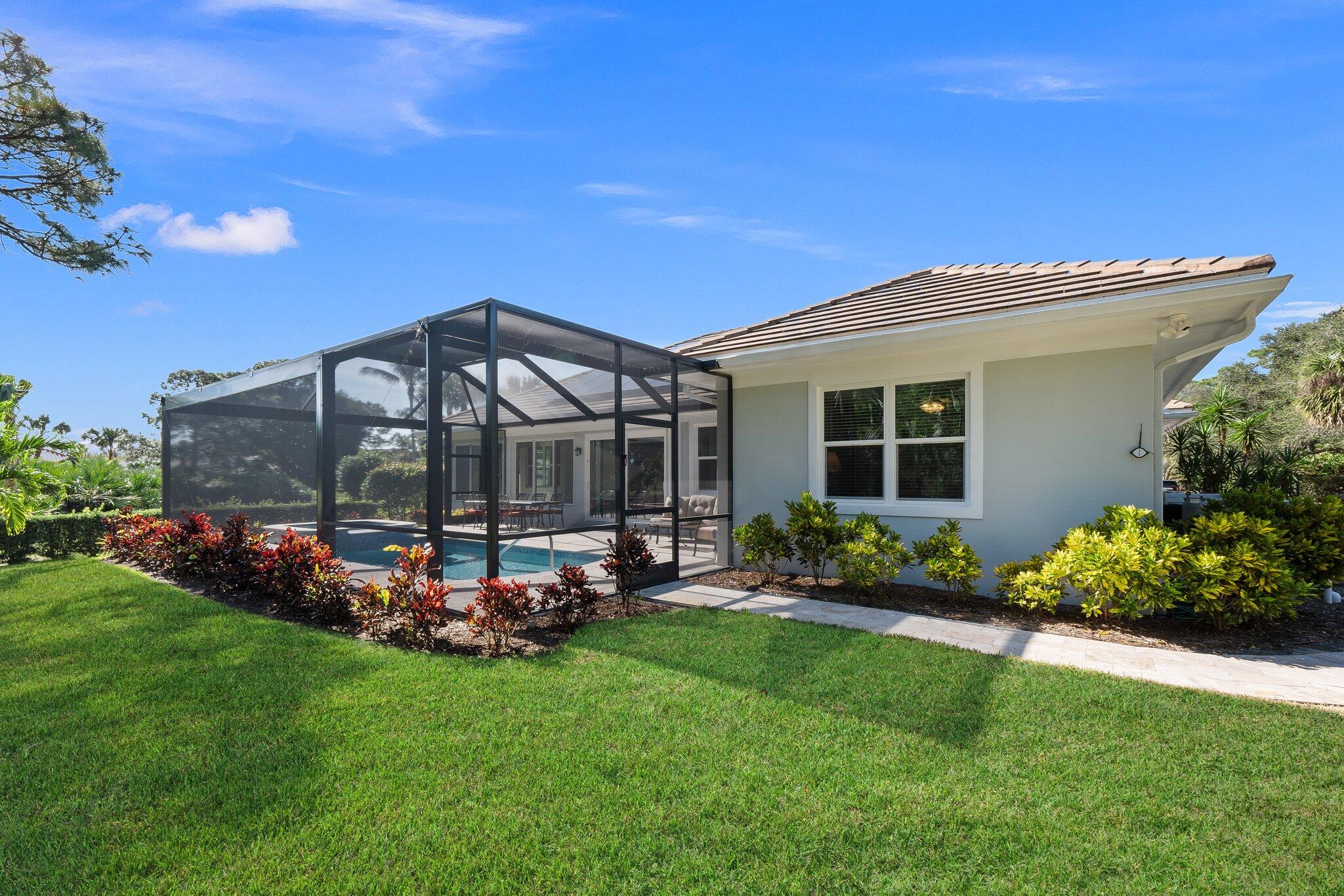 1680 Southeast Cypress Glen Way Stuart, FL 34997 - Photo 59 of 76 a view of a house with a backyard