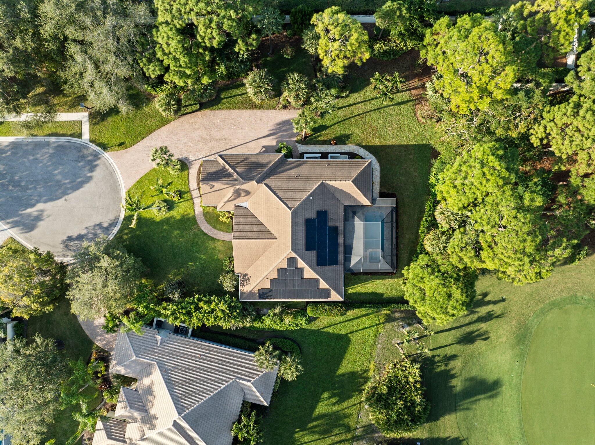 1680 Southeast Cypress Glen Way Stuart, FL 34997 - Photo 71 of 76 an aerial view of a house with swimming pool and garden