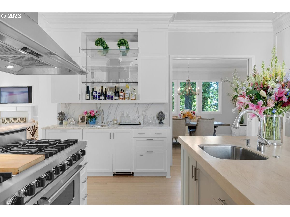 554 Southwest 48th Drive Portland, OR 97221 - Photo 14 of 48 a kitchen with kitchen island white cabinets and white appliances