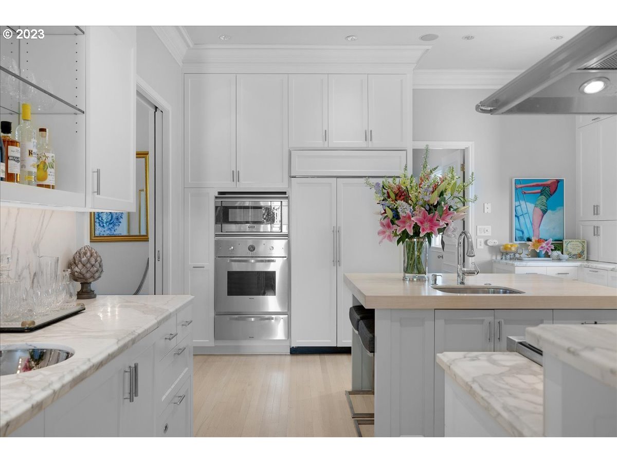 554 Southwest 48th Drive Portland, OR 97221 - Photo 15 of 48 a kitchen with kitchen island a sink stainless steel appliances and cabinets