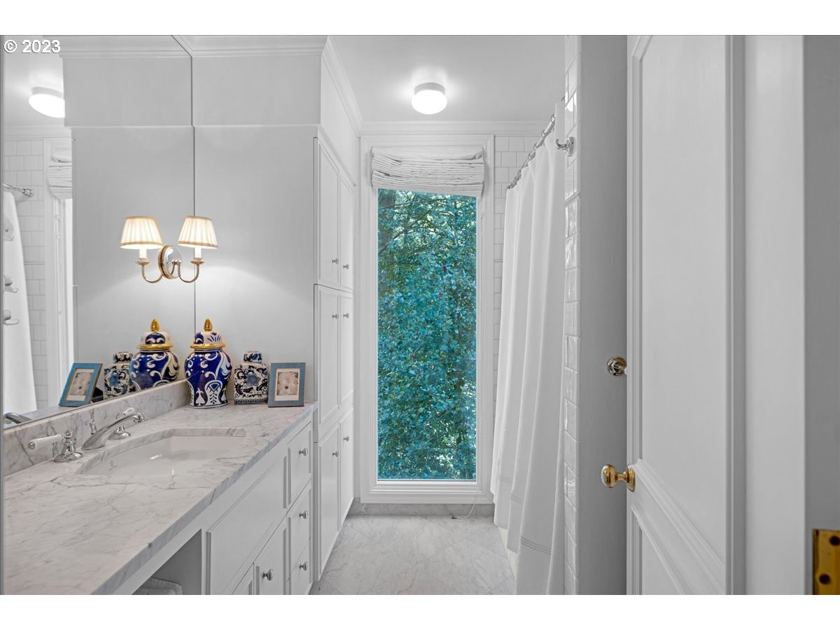554 Southwest 48th Drive Portland, OR 97221 - Photo 33 of 48 a bathroom with a sink vanity and a mirror