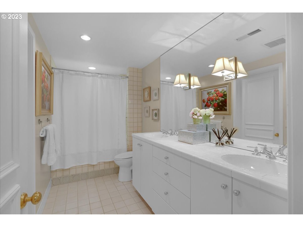 554 Southwest 48th Drive Portland, OR 97221 - Photo 41 of 48 a bathroom with a sink double vanity and a mirror