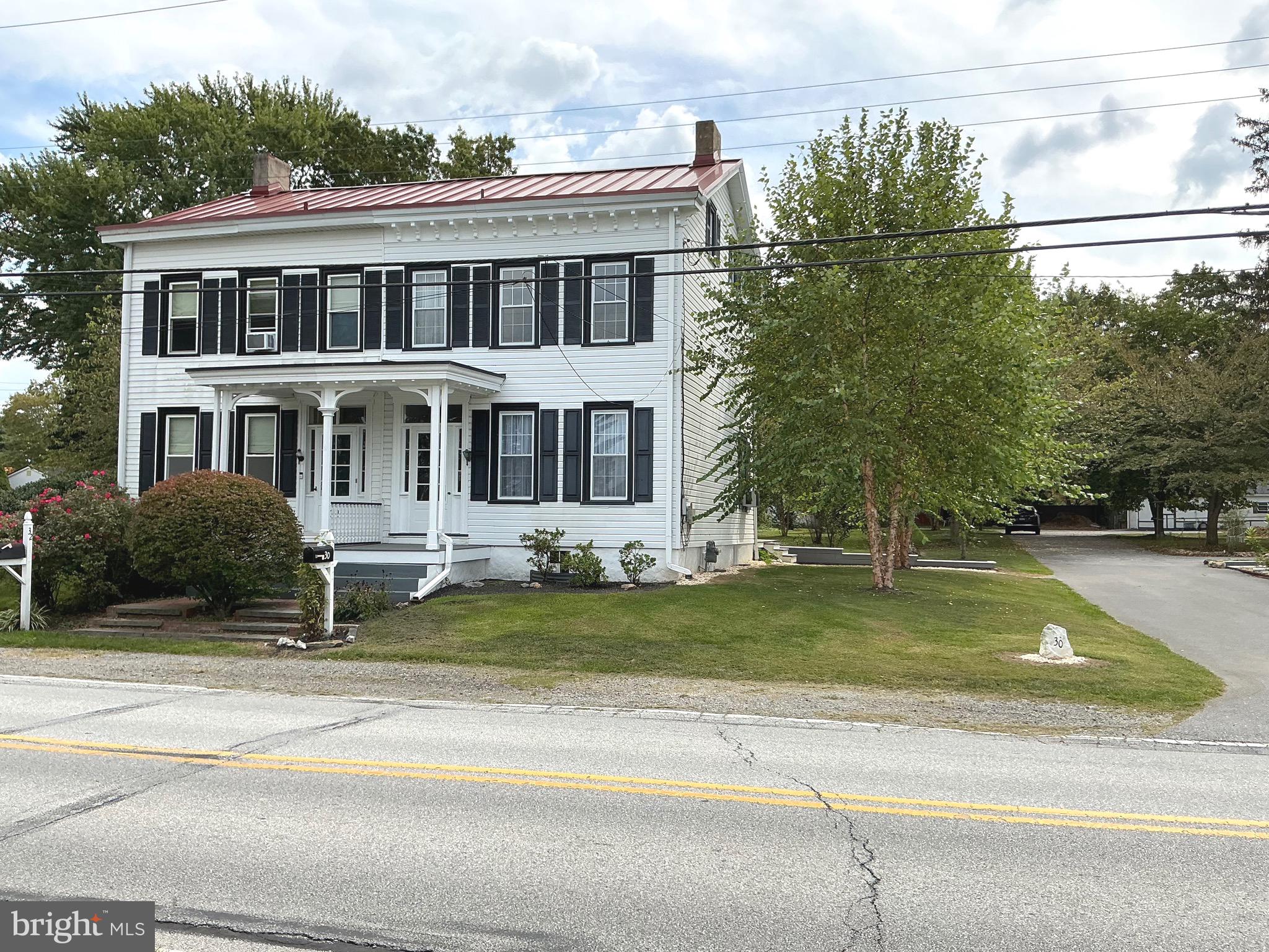 a view of a house with a backyard