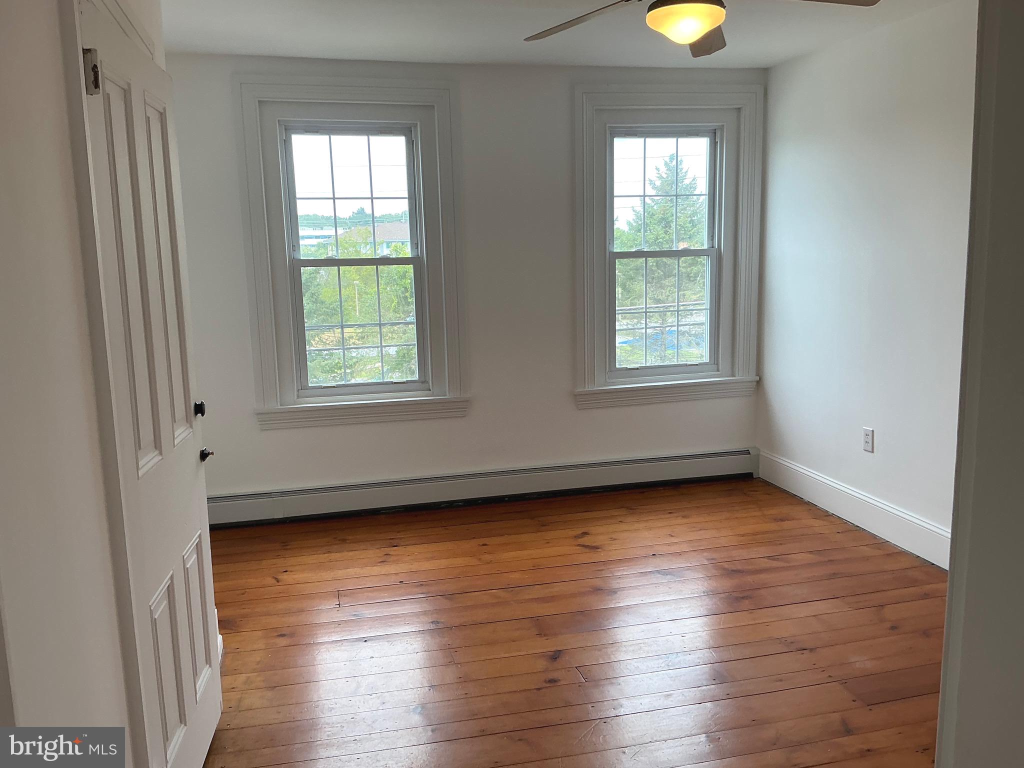 30 South Village Avenue Exton, PA 19341 - Photo 24 of 31 an empty room with wooden floor and windows