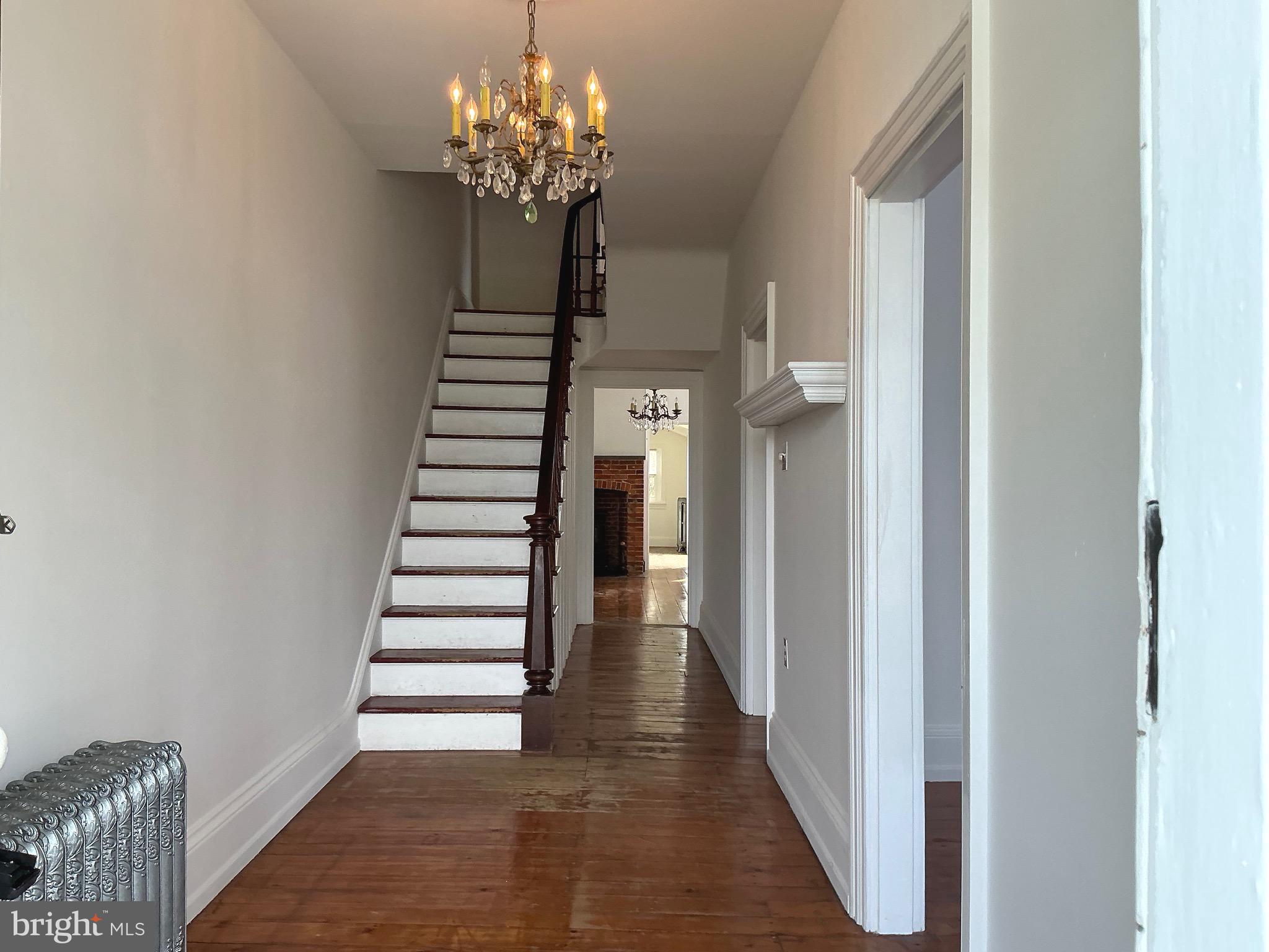 30 South Village Avenue Exton, PA 19341 - Photo 4 of 31 a view of a hallway with stairs and chandelier