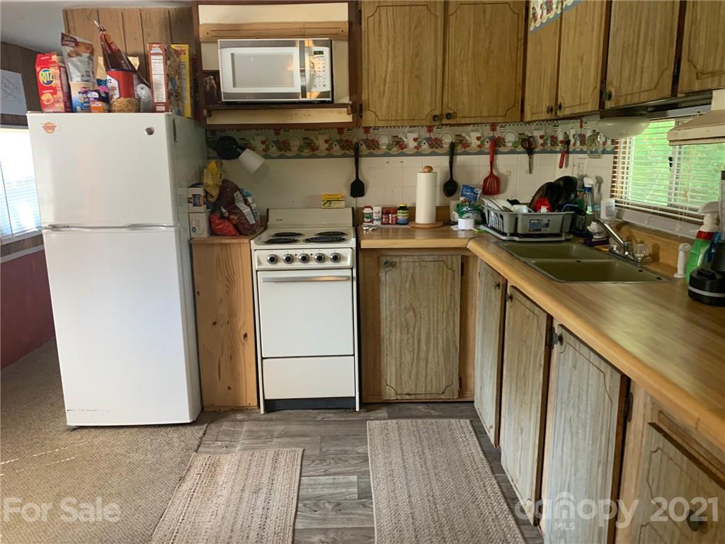 887 Meadowbrook Road, Unit 3 Chester, SC 29706 - Photo 2 of 15 a kitchen with a refrigerator and a sink