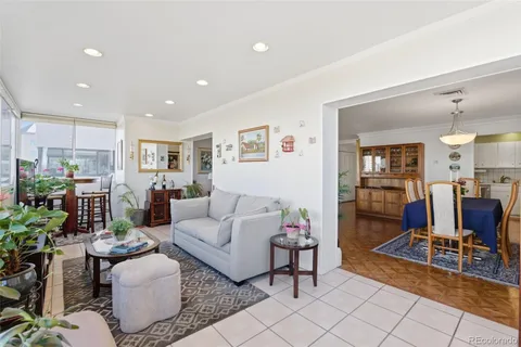 a living room with furniture and a view of kitchen