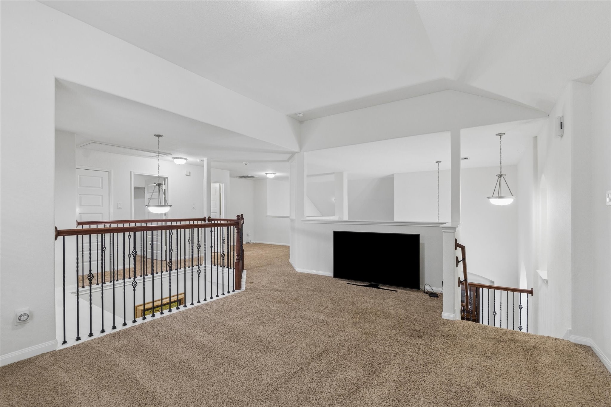 7015 Riata Hills Lane Spring, TX 77379 - Photo 20 of 33 The second-level space is highly versatile, ideal for a game room or additional living area, and serves as a welcoming transition to the secondary bedrooms. Its open design maintains a sense of connection with the main level below.