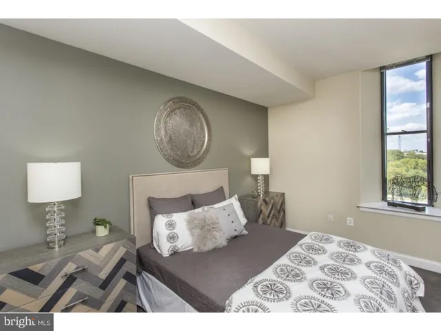 a bedroom with a bed and a lamp