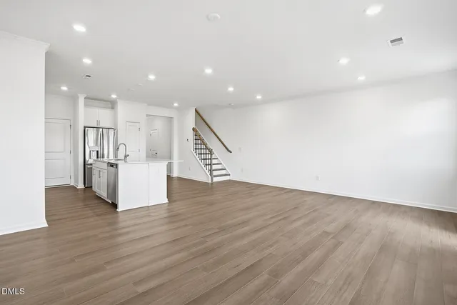 a view of kitchen with refrigerator and wooden floor
