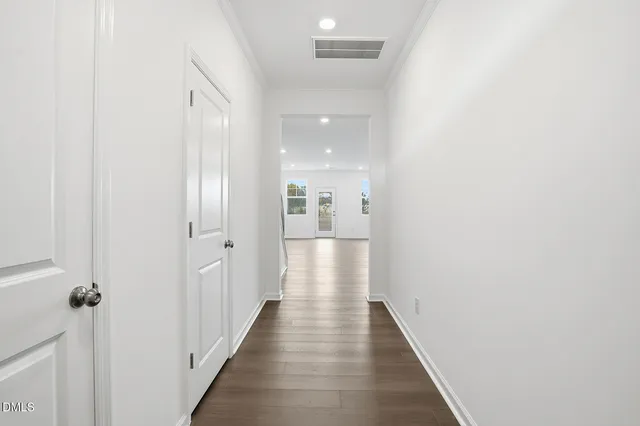 a view of a hallway with wooden floor