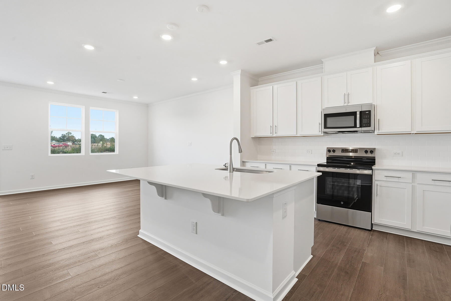 84 Blossom Fld Way Angier, NC 27501 - Photo 6 of 30 a kitchen with granite countertop a stove a sink and a microwave