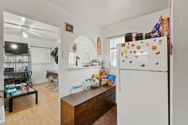 a room with furniture and refrigerator