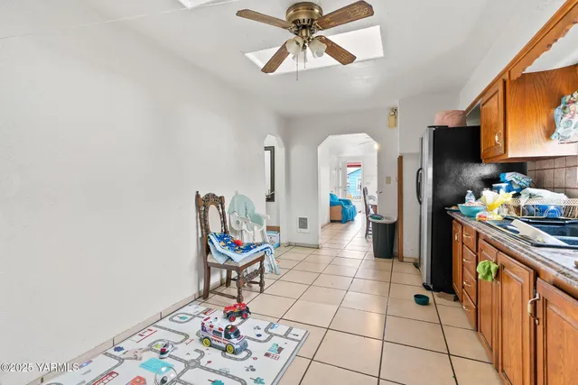 a living room with furniture and a dining table