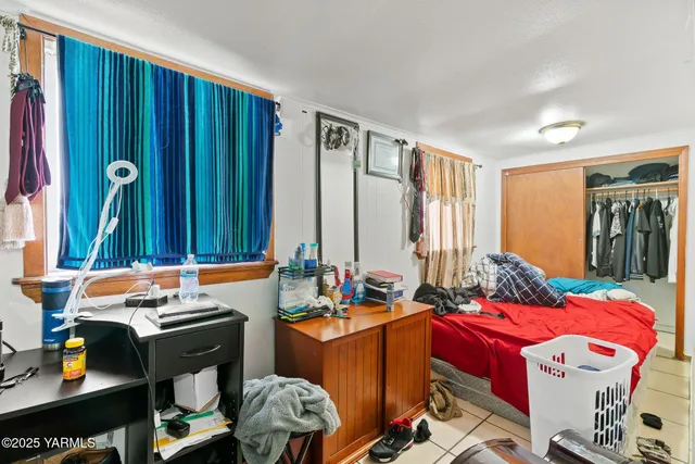 a bed room with a bed and a window