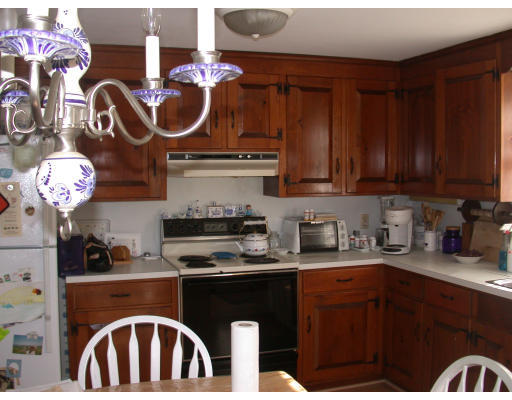 7 Timber Lane Topsfield, MA 01983 - Photo 5 of 10 a kitchen with stainless steel appliances granite countertop a sink dishwasher stove and cabinets with wooden floor