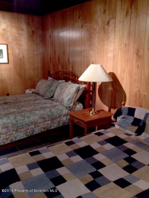 Whengreen Road Nicholson, PA 18446 - Photo 16 of 24 a bedroom with a bed and a lamp on the dresser
