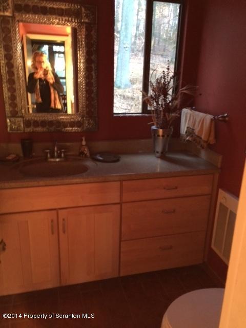 Whengreen Road Nicholson, PA 18446 - Photo 19 of 24 a bathroom with a sink mirror and vanity
