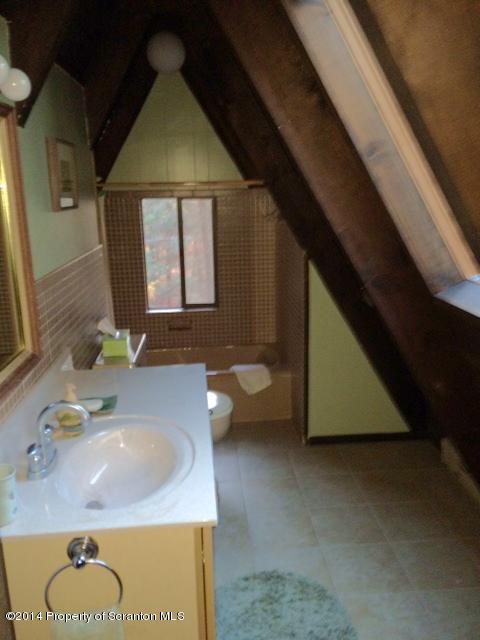 Whengreen Road Nicholson, PA 18446 - Photo 20 of 24 a bathroom with a granite countertop sink a toilet and mirror