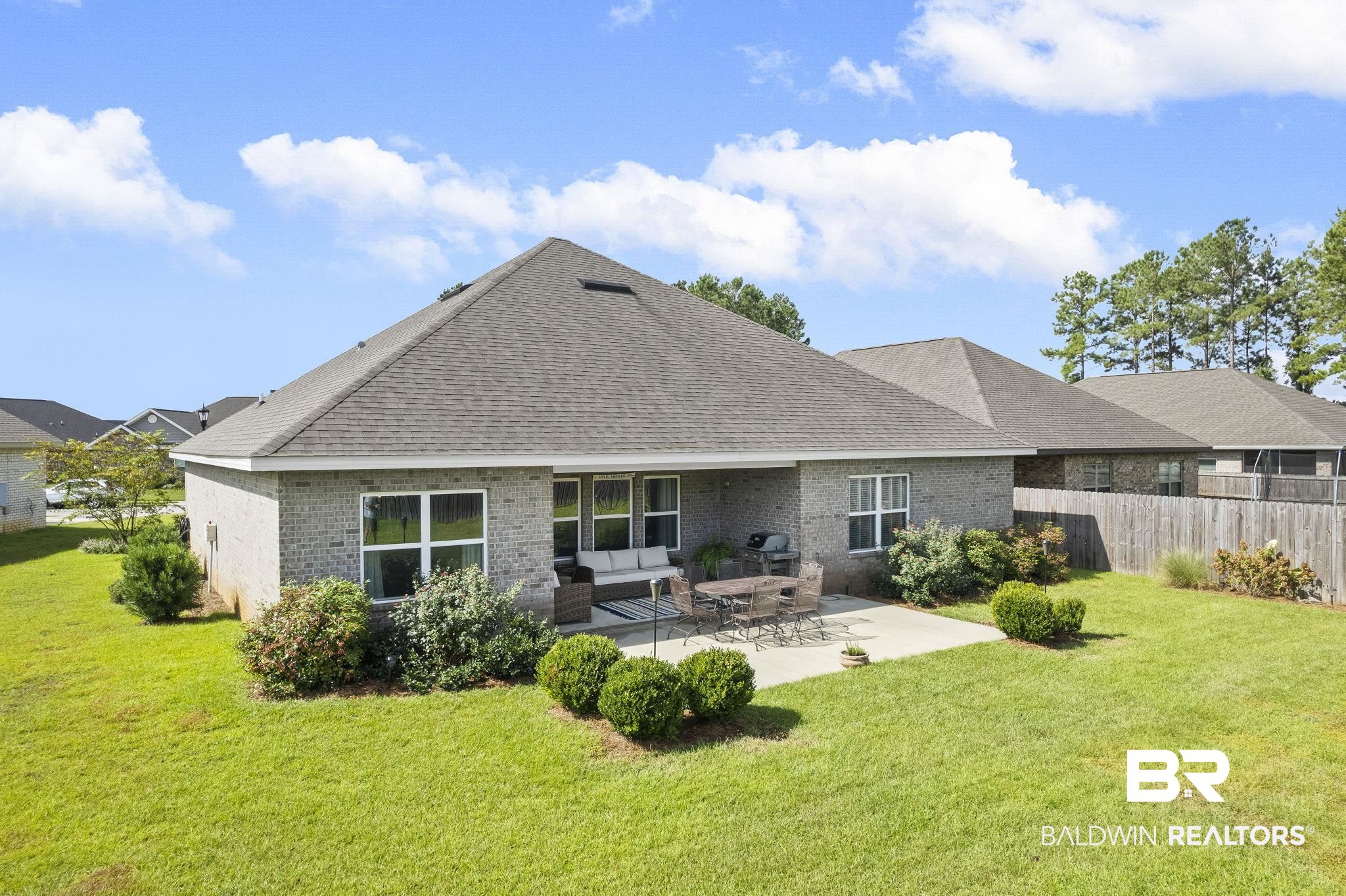 31663 Kestrel Loop Daphne, AL 36527 - Photo 73 of 86 Rear view of house with an outdoor living space, a lawn, and a patio area