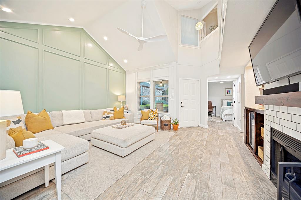 3642 Word Street Dallas, TX 75204 - Photo 5 of 29 a spacious bedroom with a bed a fireplace and a chandelier