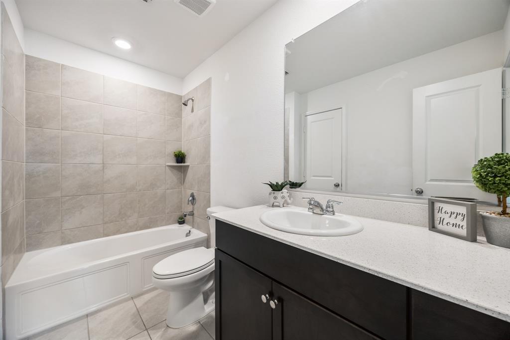 6038 Determine Lane Forney, TX 75126 - Photo 18 of 26 Bathroom featuring a dark wood-finish vanity with a white countertop and an integrated sink