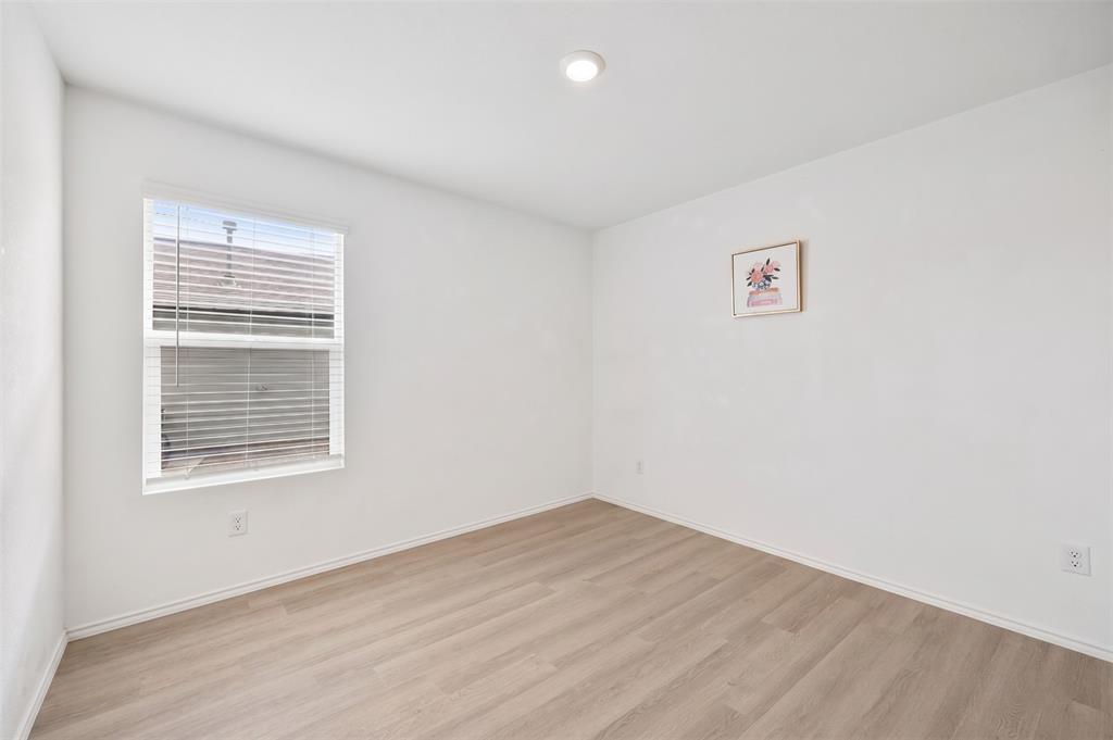 6038 Determine Lane Forney, TX 75126 - Photo 19 of 26 Bright interior room featuring a window with horizontal blinds, wood-finish flooring, recessed ceiling lighting, white baseboards, and neutral wall tones