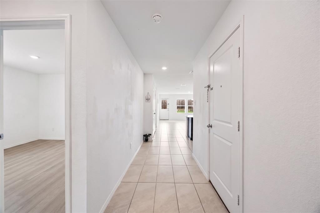 6038 Determine Lane Forney, TX 75126 - Photo 4 of 26 Entryway featuring neutral-toned tile flooring, recessed lighting, white walls, and a white interior door