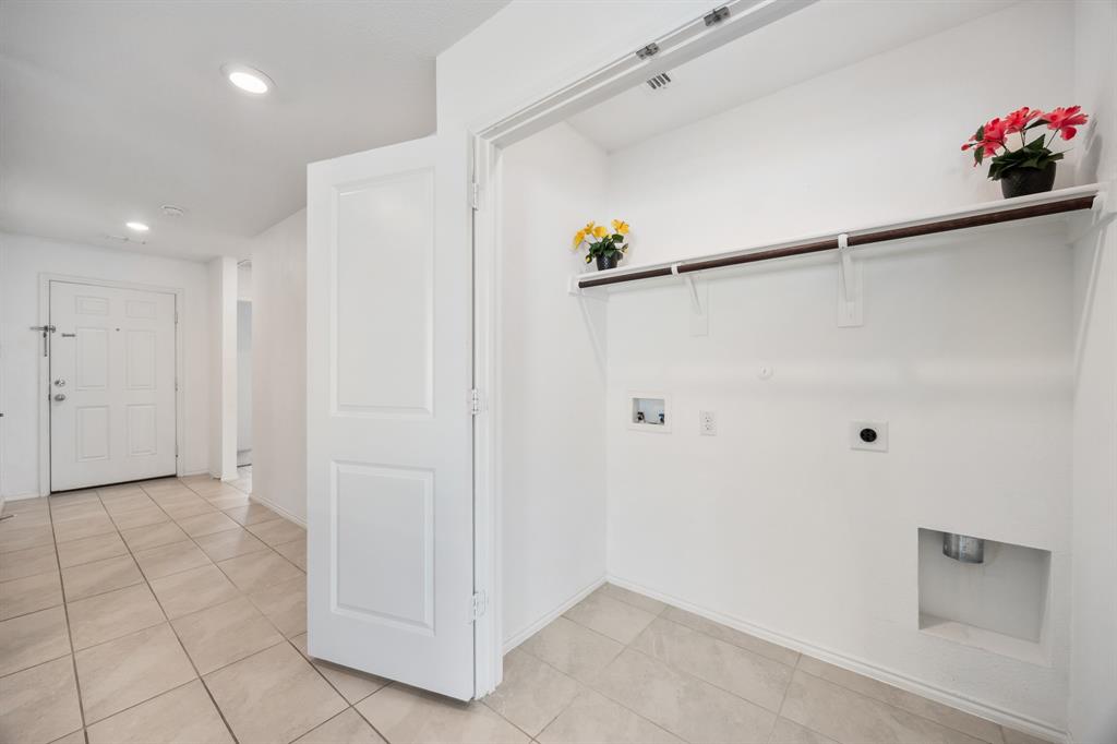 6038 Determine Lane Forney, TX 75126 - Photo 9 of 26 Dedicated laundry area featuring a built-in shelf, hanging rod, and utility hookups