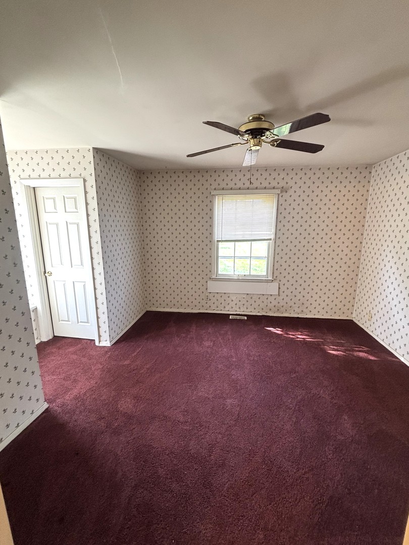 22 Guilford Road Montgomery, IL 60538 - Photo 11 of 14 an empty room with windows and ceiling fan