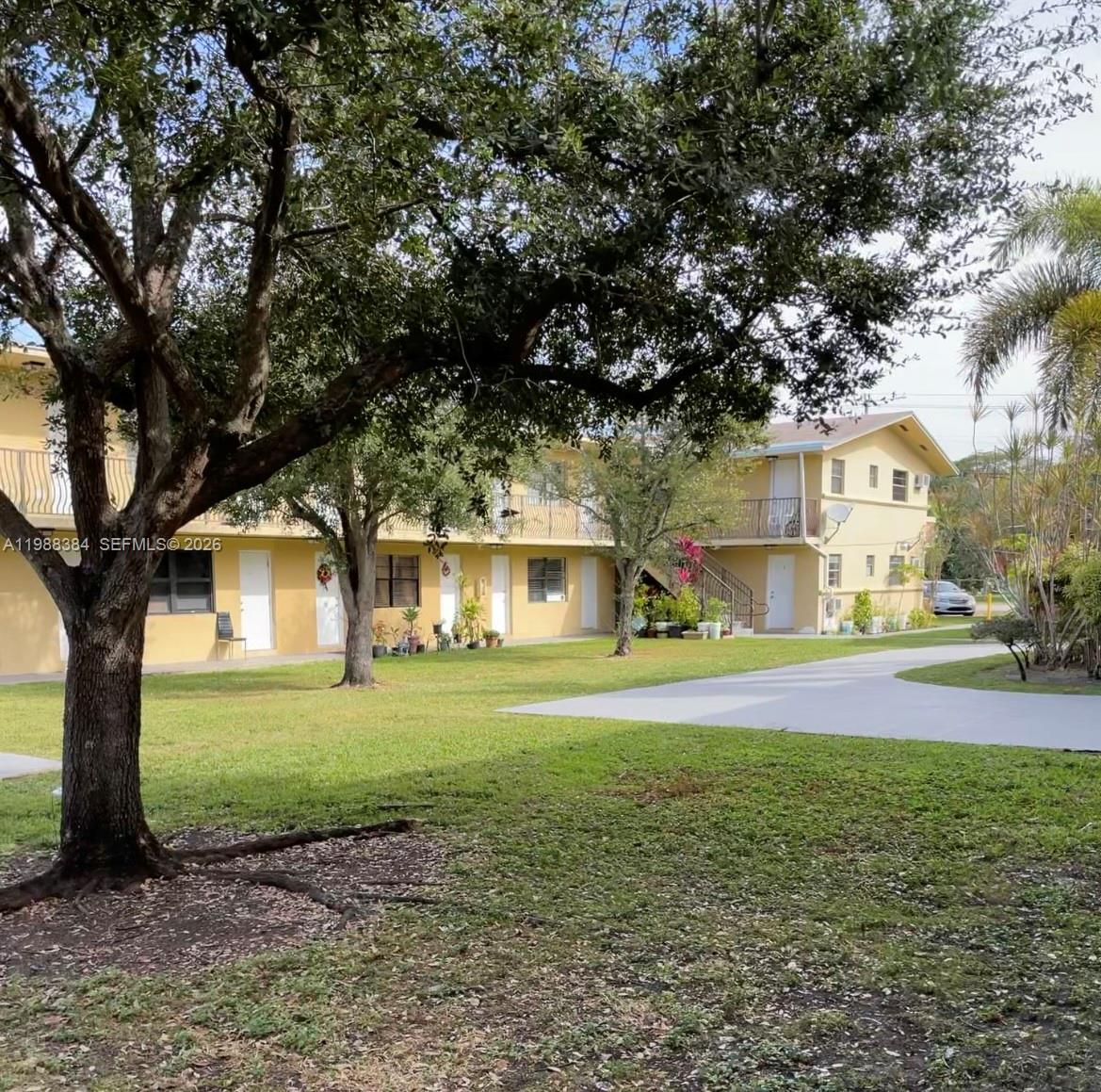 4450 Southwest 67th Avenue, Unit I Miami, FL 33155 - Photo 1 of 12 a front view of a house with a yard and garage