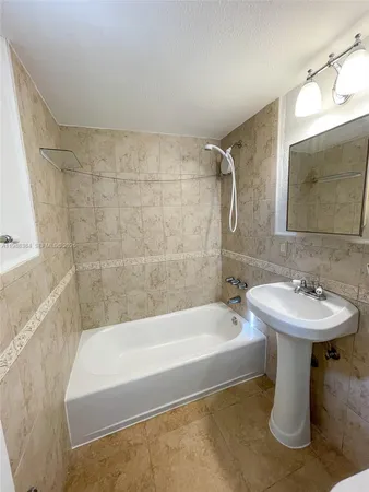 a white bath tub sitting next to a white sink
