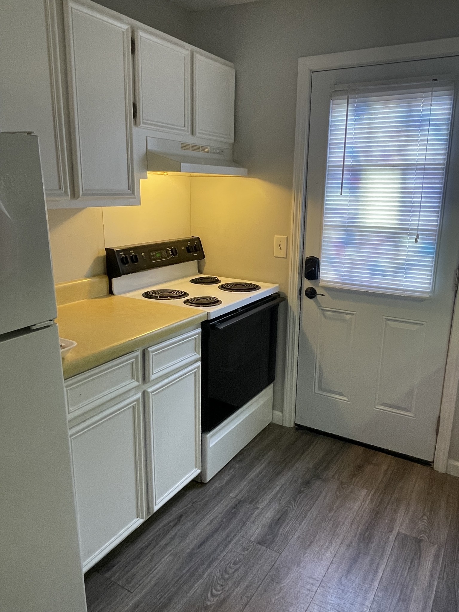 1301 Neelys Bend Road, Unit 71 Madison, TN 37115 - Photo 5 of 7 a kitchen with a stove and wooden cabinets