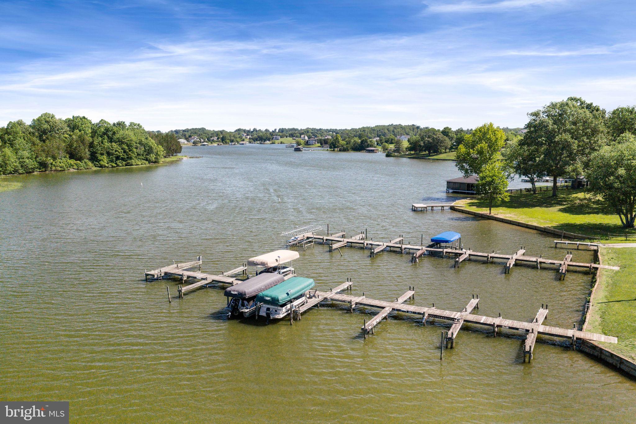 161 Troy Road Louisa, VA 23093 - Photo 49 of 60 a view of a lake with boats and trees in the background