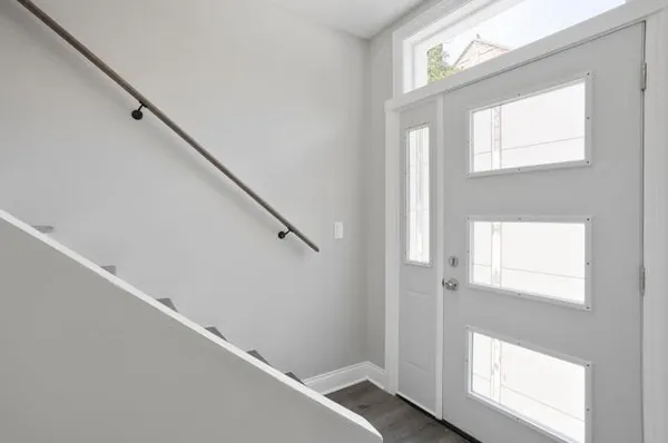 an empty room with wooden floor and window
