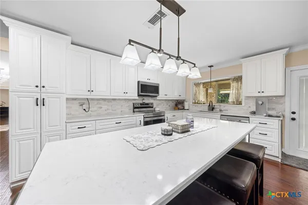 a kitchen with a sink and a window