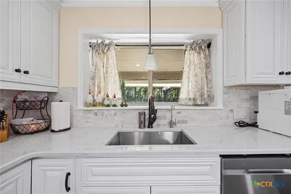a kitchen with stainless steel appliances a refrigerator and cabinets