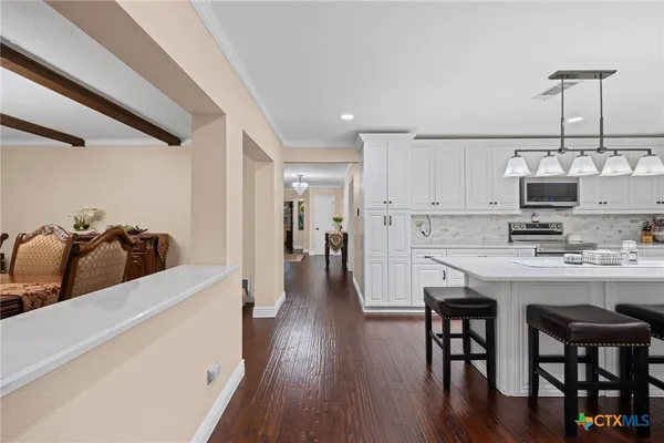 a view of a dining room with furniture and chandelier