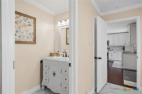 a view of a workspace with furniture and a ceiling fan