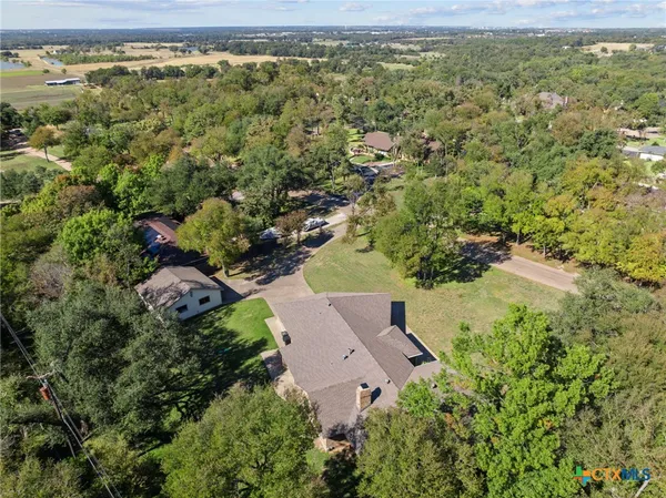 a view of a livingroom with furniture wooden floor and a chandelier