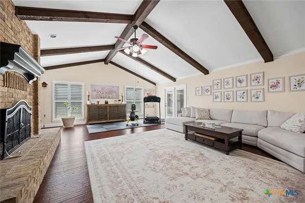 a living room with furniture and a fireplace