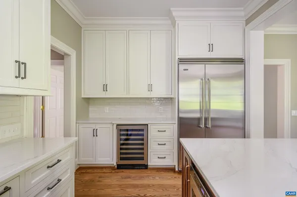 a kitchen with granite countertop a refrigerator and a sink