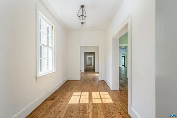 a view of a room with wooden floor cabinets and a window