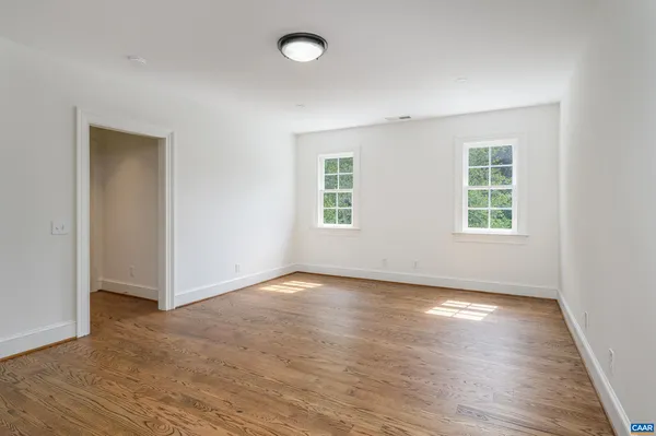 a bathroom with a granite countertop sink and white cabinets