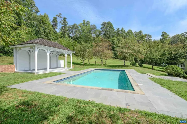 a view of pool with a yard