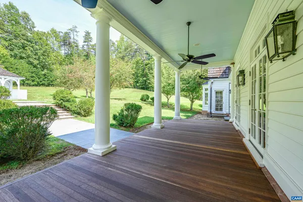 a pathway of a building with trees in the background