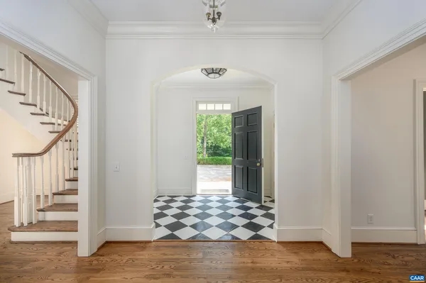 a view of a hallway with wooden door and entryway