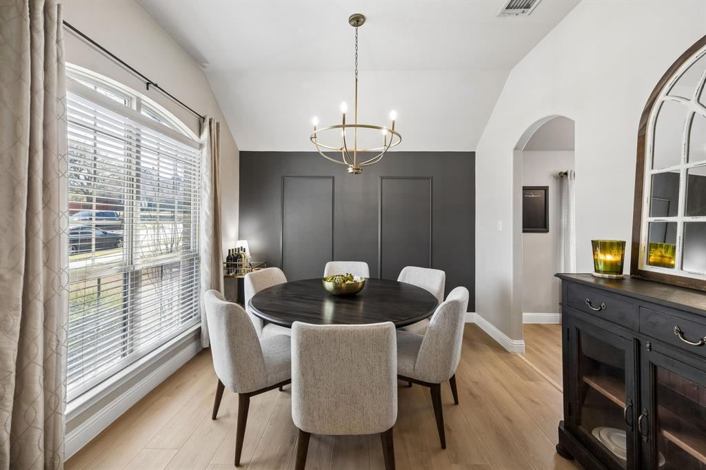 3917 Gatewick Drive Rockwall, TX 75087 - Photo 7 of 34 a dining room with furniture a chandelier and wooden floor
