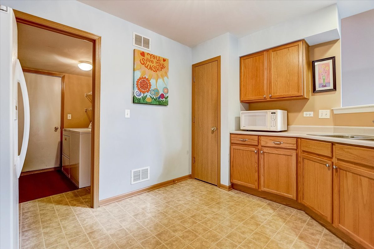63 Rolling Oaks Road, Unit B Sugar Grove, IL 60554 - Photo 11 of 23 a view of a kitchen with wooden floor and window
